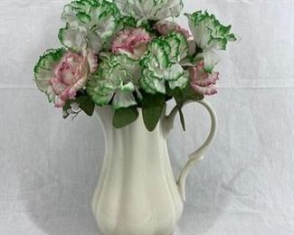 White ceramic handled vase with fake pink and green flowers