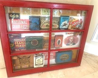 Collection of vintage tobacco tins in a shadowbox frame