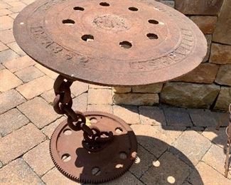 Old manhole cover made into a side table