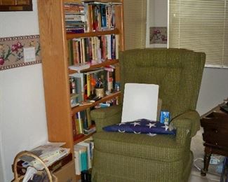 Wood Bookshelf , Books ; Dark Green Swivel Recliner.