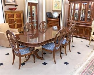 Antique Formal Dining Set comes with 6 chairs and table pads! The chairs have been recently re-upholstered with a beautiful navy and white fabric. There is also a roll of fabric that is included - in case you ever need to recover or want to use for something else. With two leaves, this table measures approximately 102" x 44".