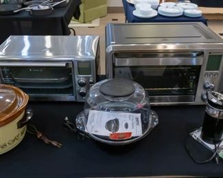 Small kitchen appliances including a convection oven on the right - air fryer on the left.  Orville Red popcorn popper and Mr. Coffee grinder on the right.