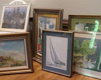 Group of pictures waiting to be hung. There are three times this many.