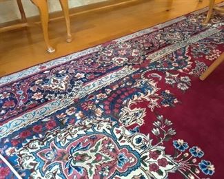 9' x 12' rug, burgundy red ground with blue and natural accents. Signed.