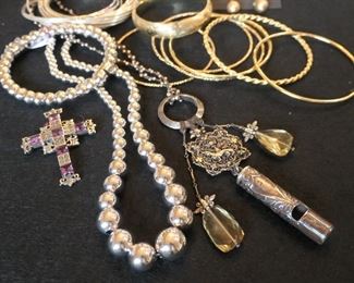 Sterling, except for the 14k gold bangles in back right.