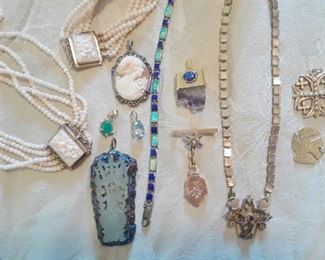 A varied view of jewelry in the sale. James Avery 14k dove lower right. Two Victorian pieces in center right.