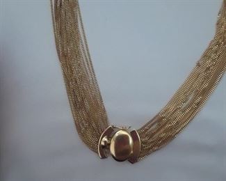 18k gold multi strand necklace with decorative clasp that can be worn in front or in back of neck. 24"