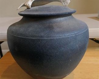 Raku glazed pottery with bone fragment handle on lid.