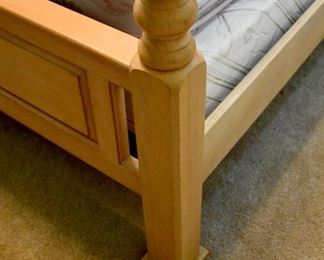 Wood and metal four-poster bed (foot detail)