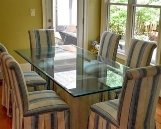Glass top dining table with six (6) upholstered chairs and two (2) stone bases