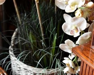 wicker planter and faux orchids