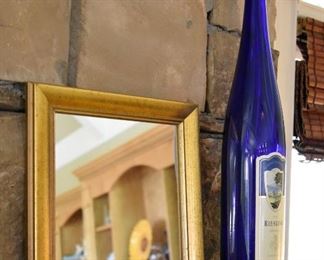 framed mirror, blue bottle