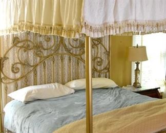 Brass four-poster bed with canopy