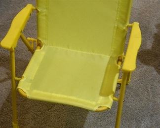 small child's yellow lawn chair