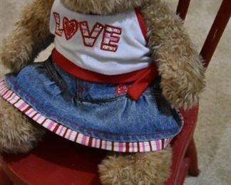 child's tiny red chair and teddy bear