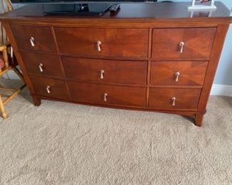 23.   Contemporary 9 drawer dresser with mirror • mahogany finish with nickel hardware • 80"H x 66"W x 23"D • $250
