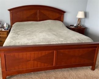 22.   Contemporary King Bed with nightstand • includes mattress • mahogany finish with nickel hardware • bed 58"H x 84"W x 87"D • nightstand 28"H x 28"W x 18"D • $350