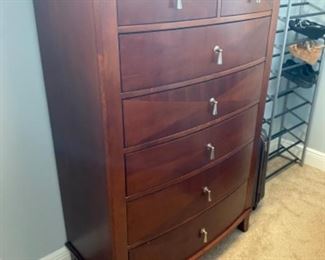 24.   Contemporary tall chest • mahogany finish with nickel hardware • 57"H x 38"W x 20"D • $200