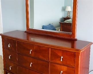 23.   Contemporary 9 drawer dresser with mirror • mahogany finish with nickel hardware • 80"H x 66"W x 23"D • $250