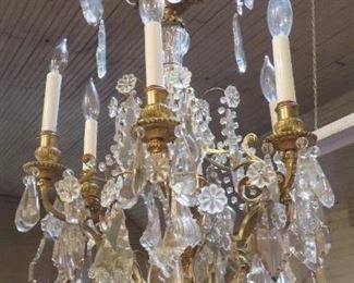 Second of 2 vintage French gilt brass chandeliers dripping with high quality crystal prisms