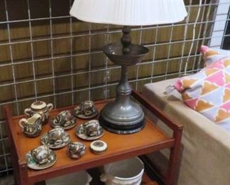 Teak tea or bar cart holds fine signed Japanese satsuma porcelain, Italian planters and a striking pewter chinoiserie lamp