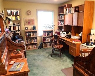 Office with lots of shelving, desks, books, and tons of office supplies!