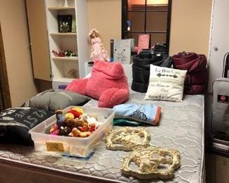 pillows, wall decor, stuffed animals, doll, mirror, sleeping bag, queen bed