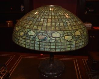 A Tiffany Studios leaded glass acorn lamp shade in beautiful condition, having a 20 1/4" diameter x 8 1/2" tall shade stamped "Tiffany Studios New York"  and numbered 1798. The bronze base in the Art Nouveau style and is damaged and missing a part that could easily be replaced, however the base was turned upside down and nailed to the ceiling to create a chandelier effect. The shade miraculously survived the trauma and is in excellent condition! You are buying the shade and the base will come with it.