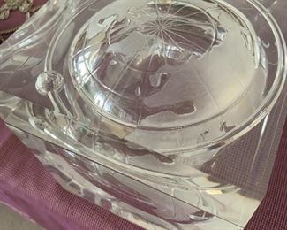 Lucite ice bucket with world globe carved in it.