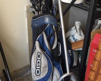 Several sets of golf clubs .