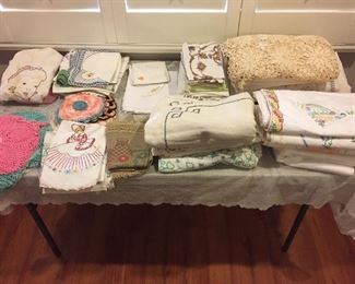 Tables full of antique linens. 