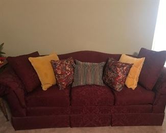 Burgundy camel back sofa