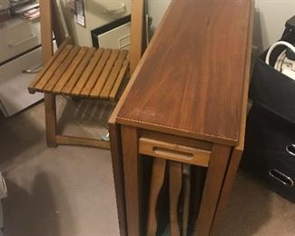 Mid century folding table with folding chairs inside cabinet