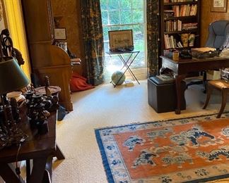 Bookcase and upholstered desk chair, Asian rug, writing desk, lots of bird books