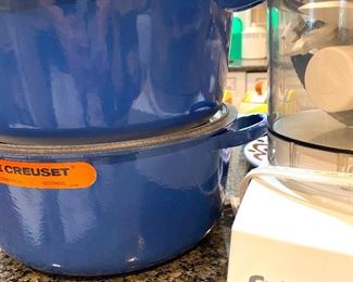 two Le Creuset pots with lids; one never used