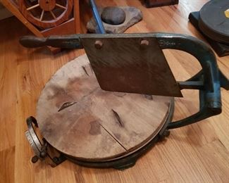 Well...we think it is a meat cutter with some type of measuring device on the left. 