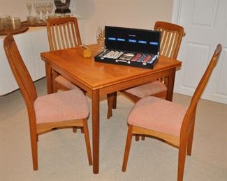 Amazing 1960's Mid Century Modern Ansager Mobler Expandable Teak Dining Table, Made in Denmark, 33.5" x 30" x 33.5", Includes Four Teak Slat-Back Cushioned Chairs.
