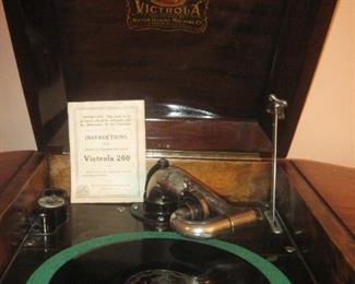 Victrola with open top with vintage records.