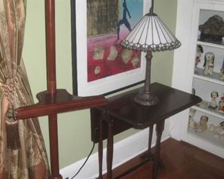 Easel, small drop leaf table, lamp and artwork.