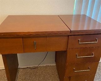 Sewing machine in a great mid century cabinet.  Could be easily turned into a desk if you work from home.