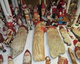 Many hand carved wood Santa's
