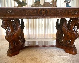 20% off all furniture 9 am Saturday Marble top table with four carved wood Griffins