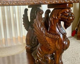 Close-up of previous table showing 1 of 4 carved Griffins 20% off furniture at 9 am Saturday 