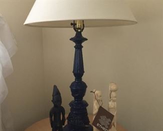 Blue glass lamp and carved figures.