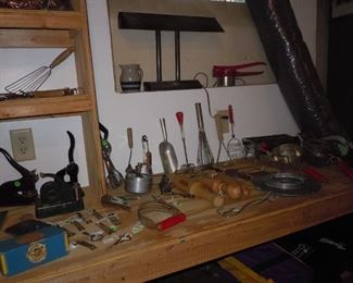 Odds and ends - several seal makers, wooden pestles for food mills, industrial desk lamp,  old kitchen  utensils
