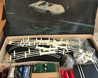 1960’s Strombecker electric race track with cars and accessories. Designed for both cars to race against each other.