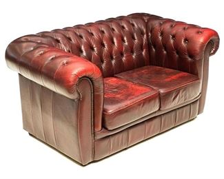 Vintage two-seat sofa, having ox blood tone leather upholstery in the Chippendale style