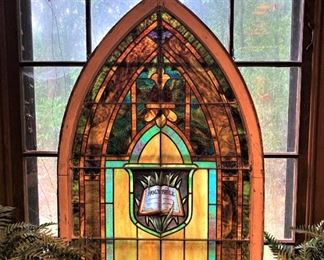 Incredible antique "Holy Bible" stain glass window in the master bathroom
