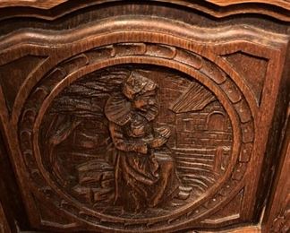 Each chair has a different carved scene. 