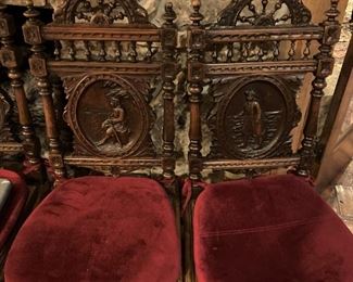 Two of four more hand-carved antique chairs